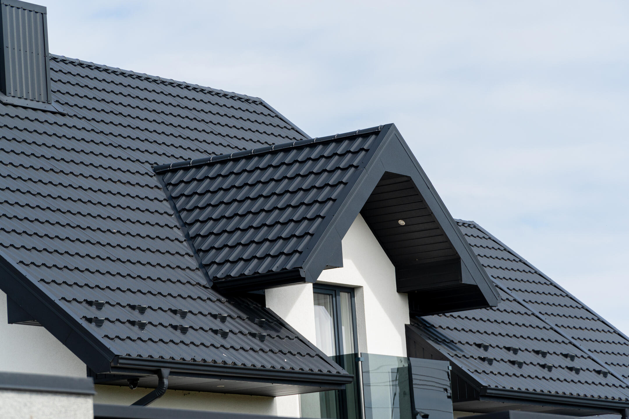 metal roofing port st lucie fl-black metal shingles on white house