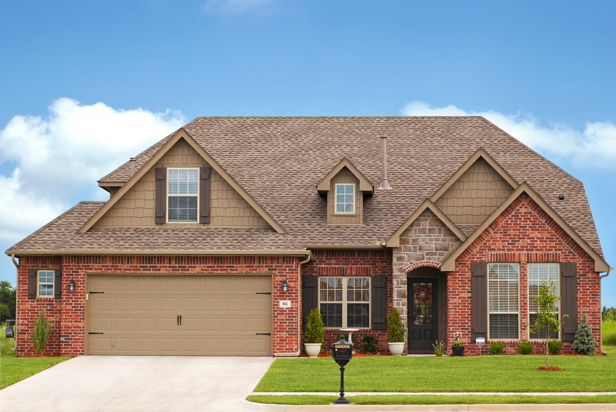 roofing palm beach fl-brick sided house with brown shingles