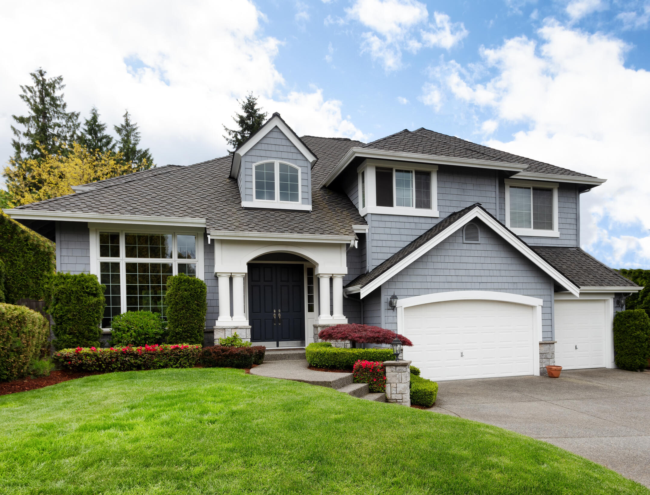 roofing stuart fl-gray sided house with gray shingles